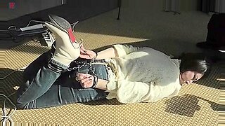 Submissive brunette gagged and restrained in heels